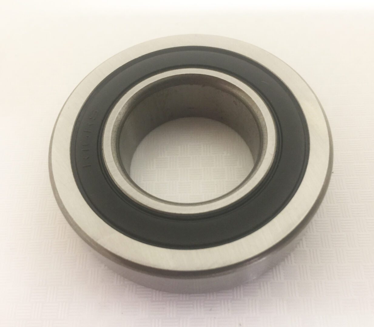 A close up of a bearing on top of a white surface