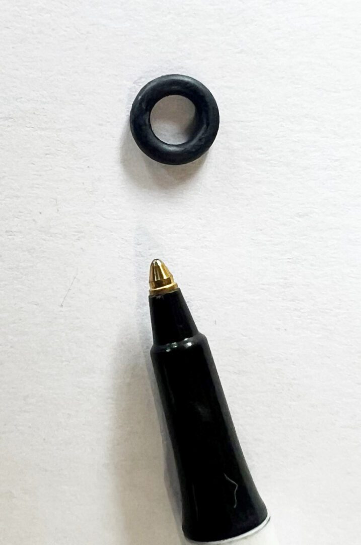 A black pen and some black rubber rings