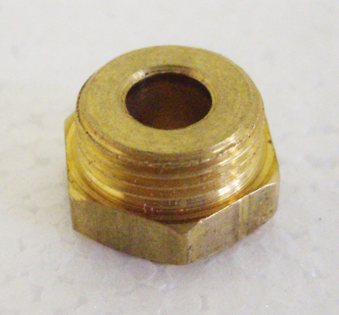 A close up of the side of an empty brass nut.