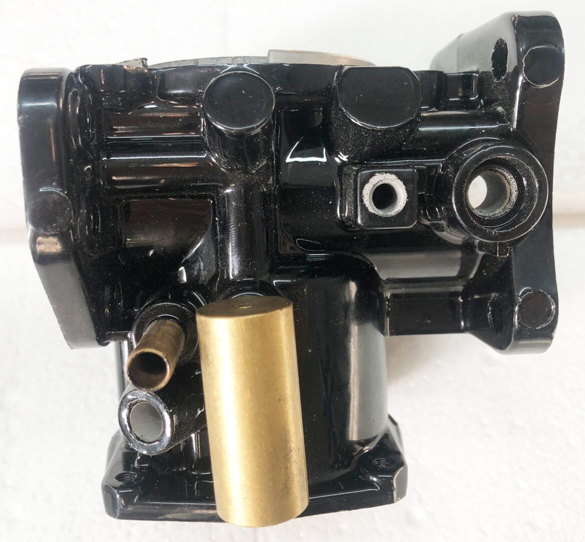 A black and gold engine block with some gold parts