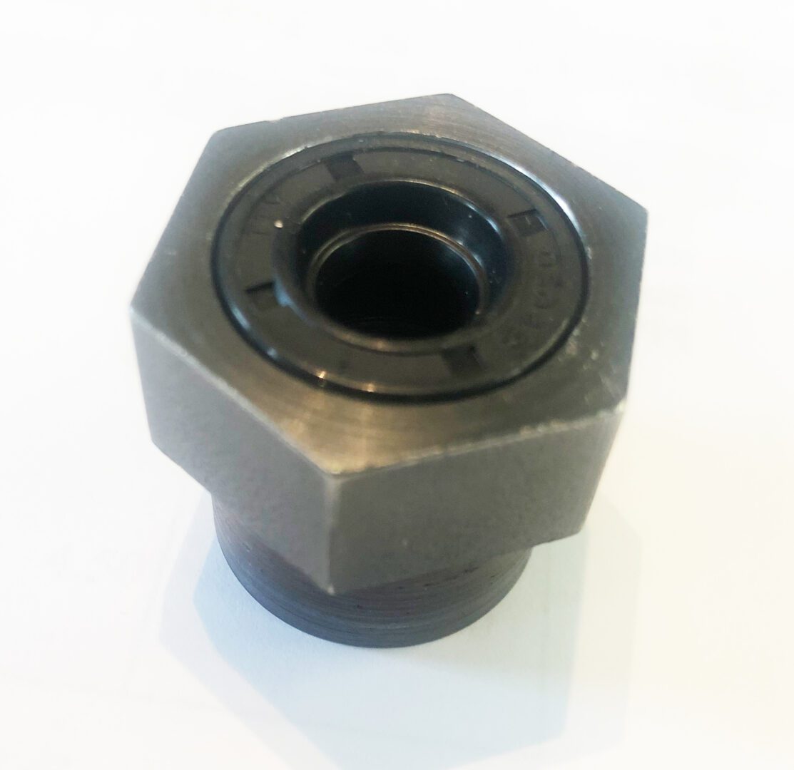 A metal nut with a black ring on it.