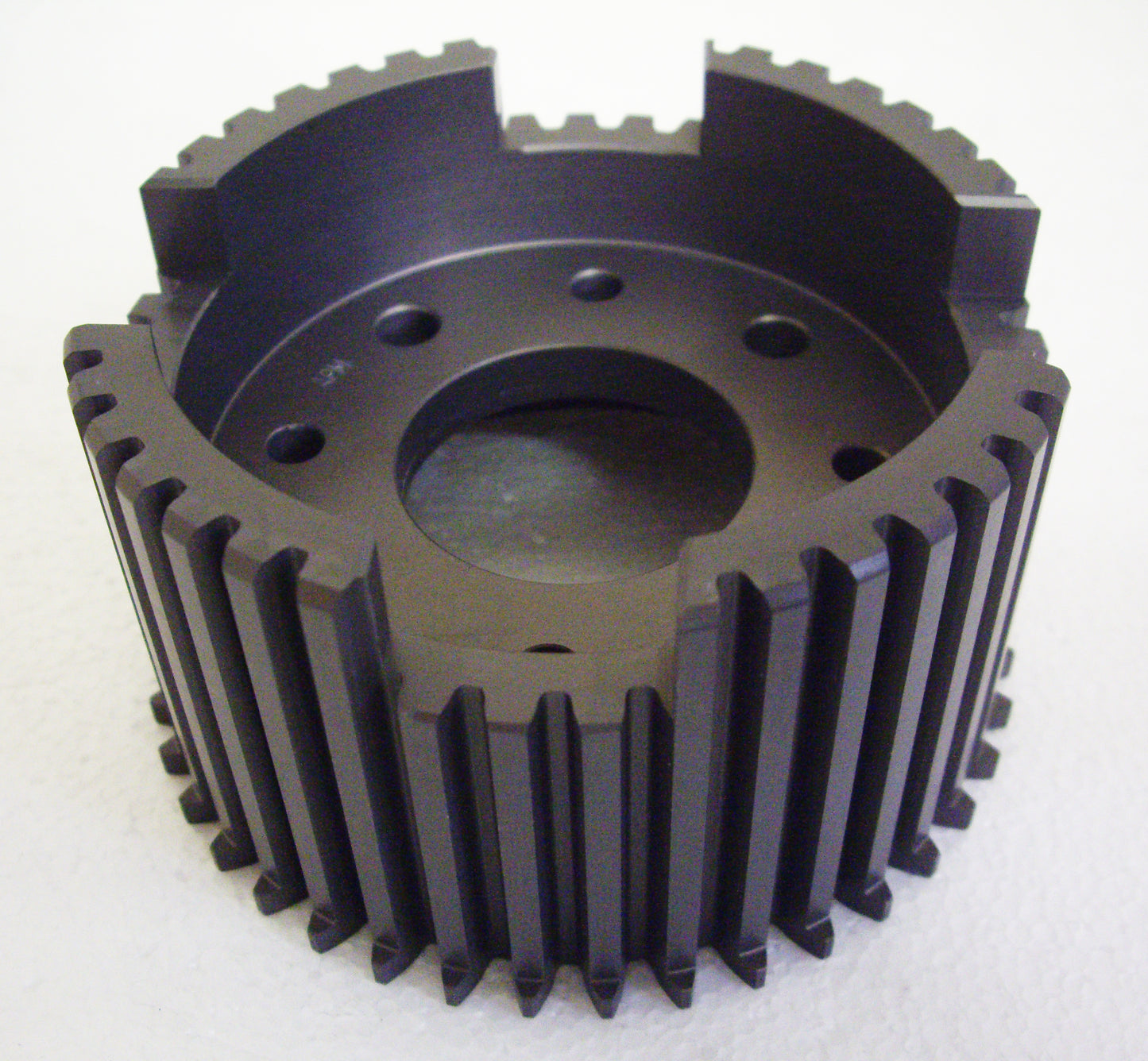 A black metal gear with holes in it.