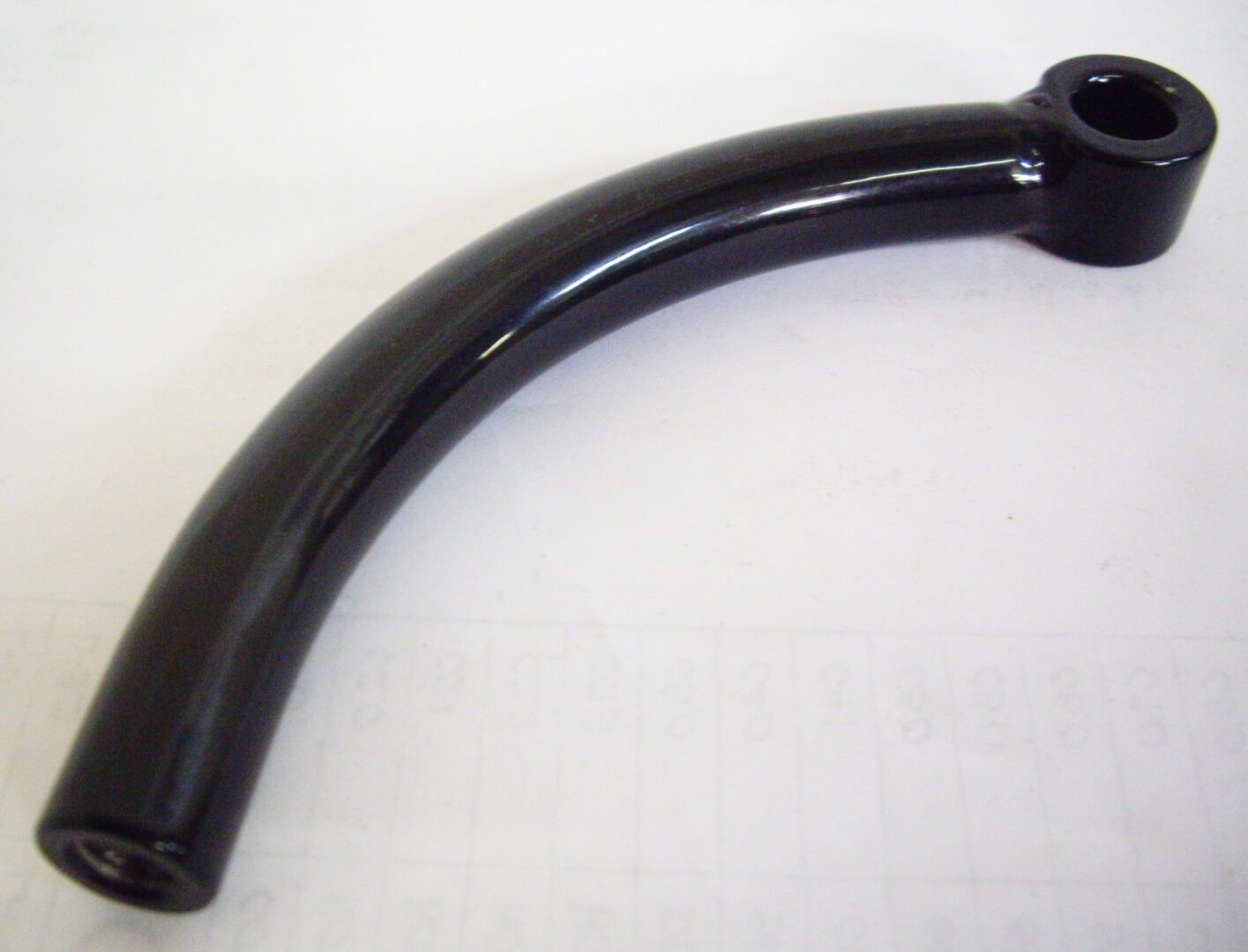 A black handle on top of a white table.