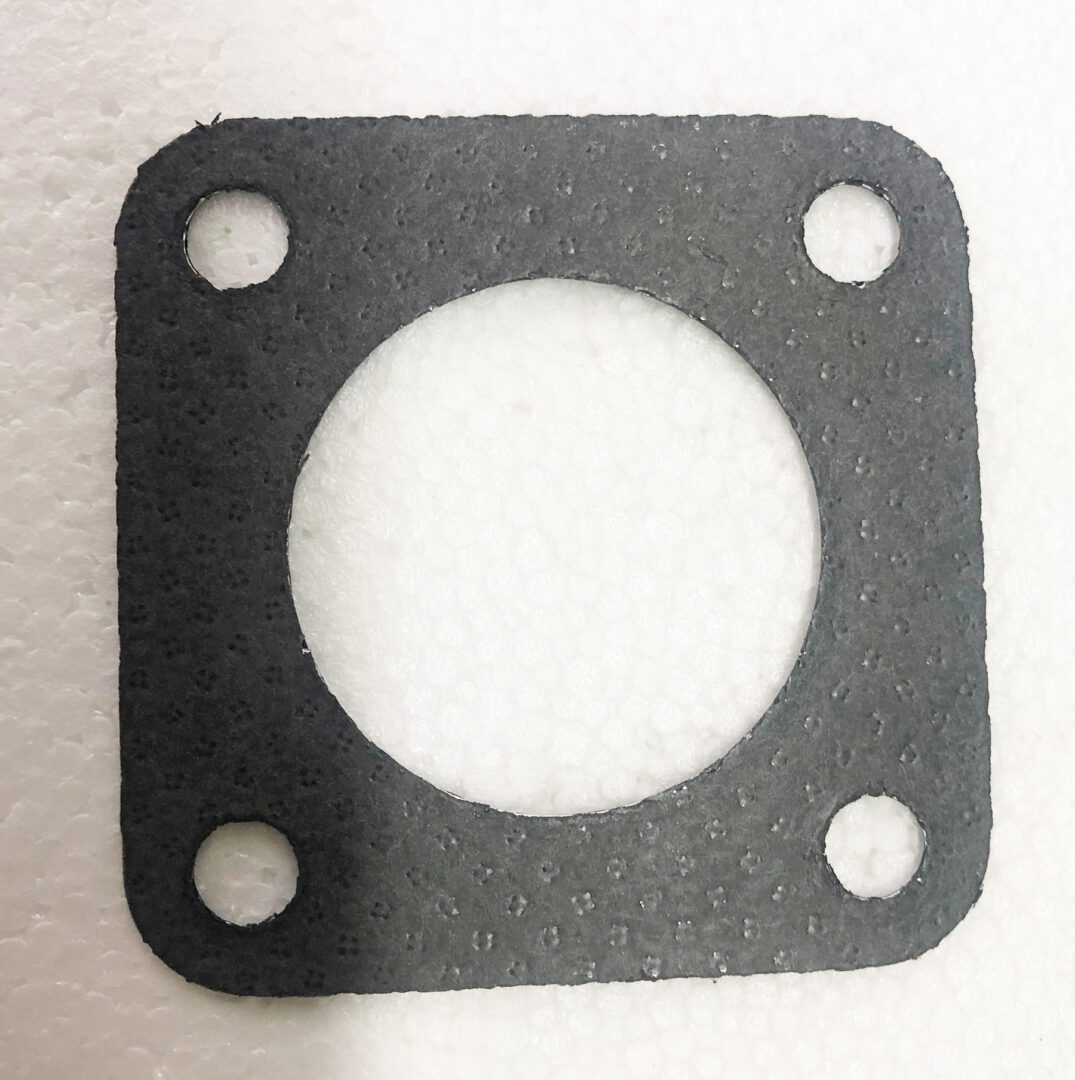 A black gasket is sitting on top of the floor.