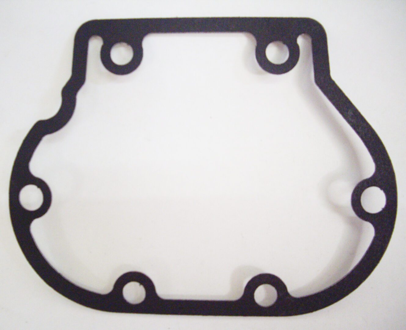 A black gasket that is on the side of a white table.