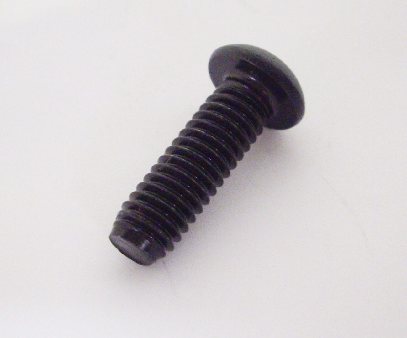 A black plastic screw with a hole in it.