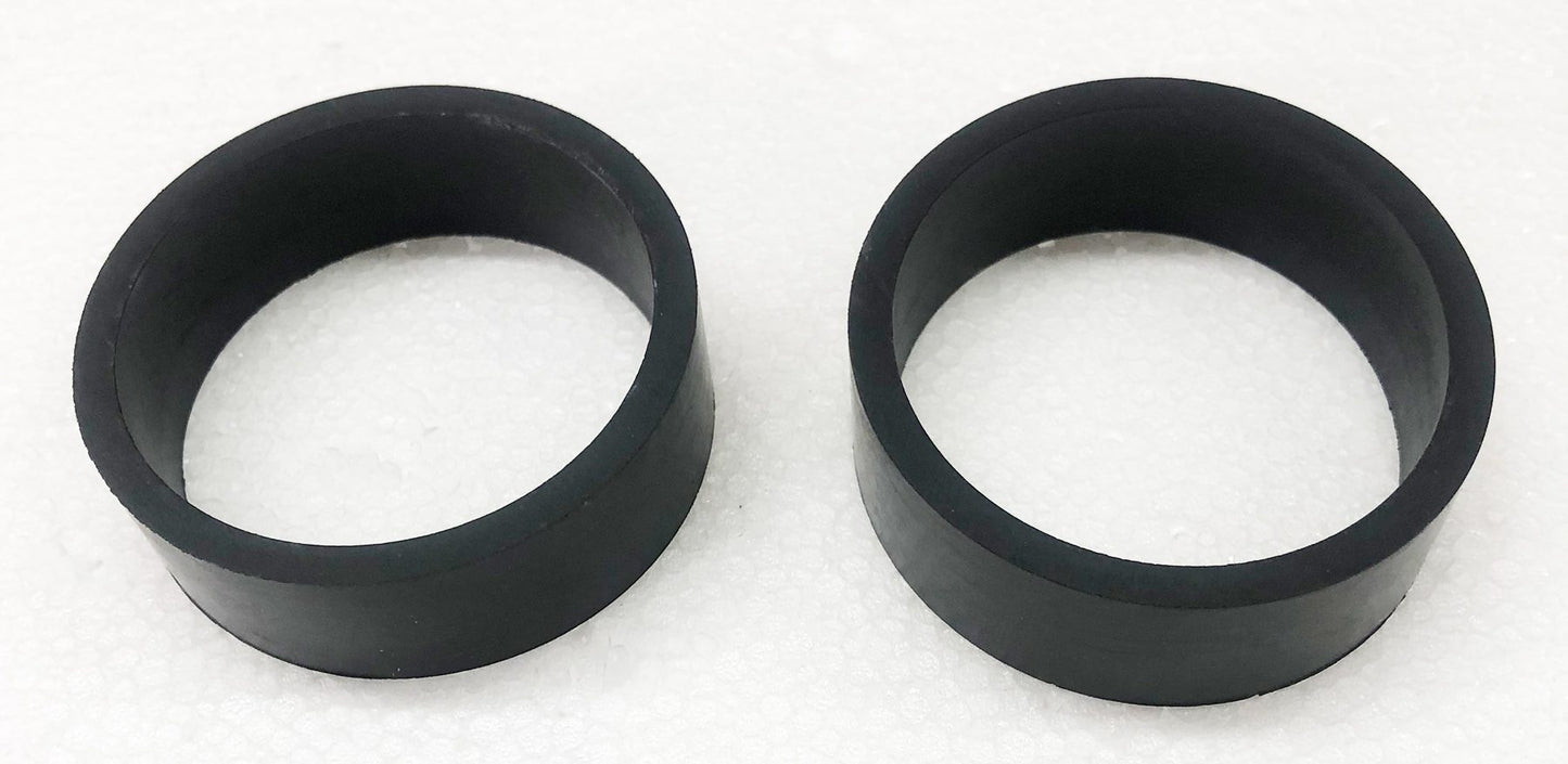 A pair of black rubber rings sitting on top of a white surface.