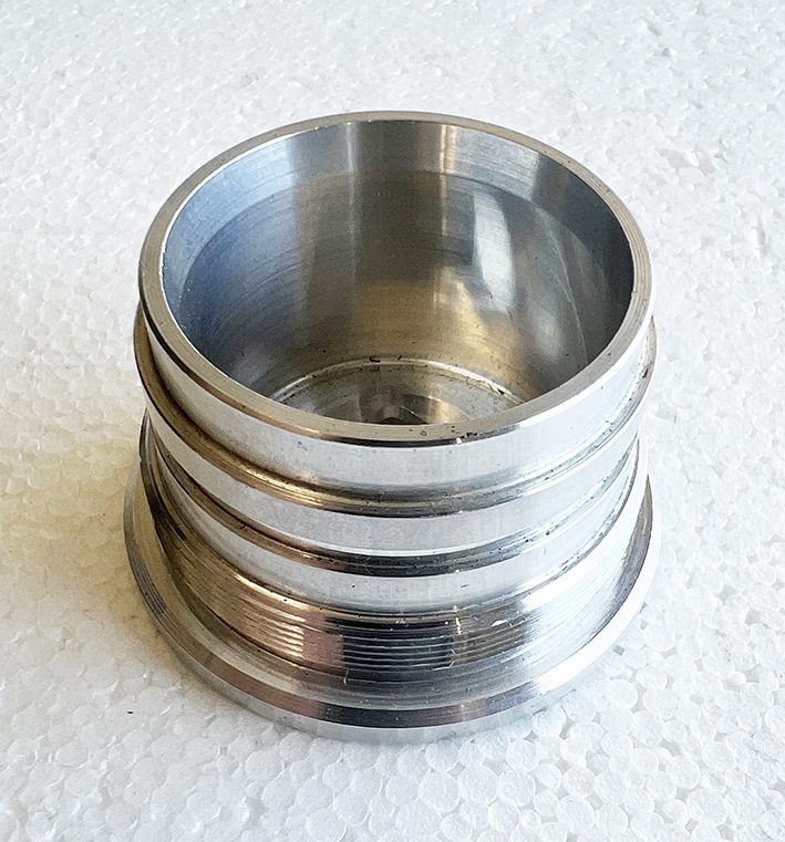 A metal object sitting on top of a white surface.