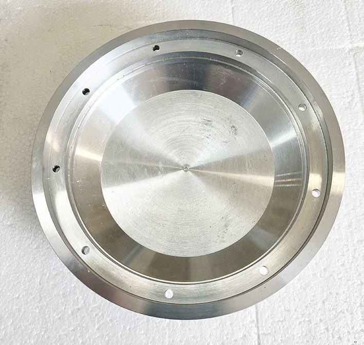 A metal bowl sitting on top of a white table.