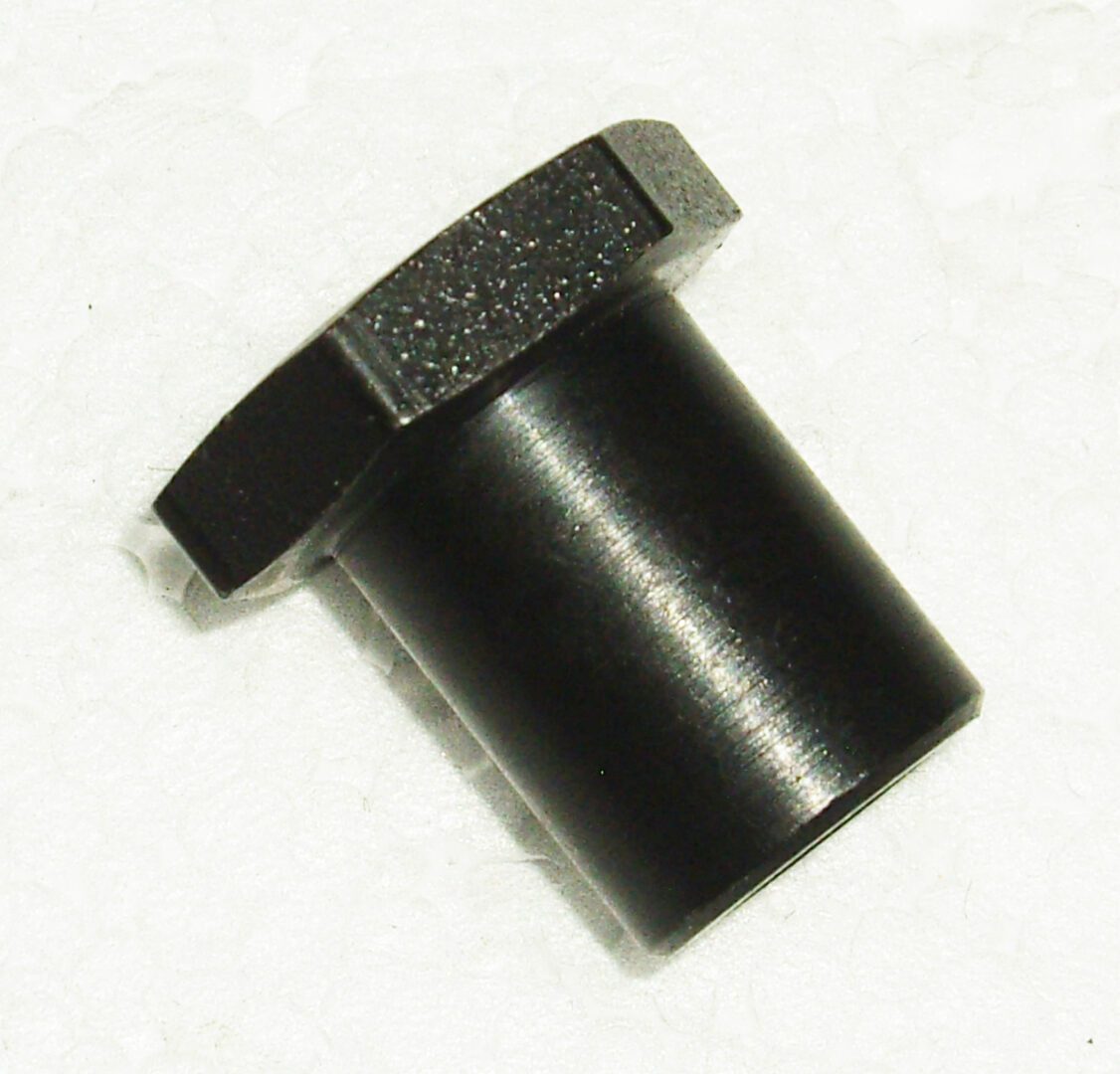 A black plastic cap with a metal ring on it.