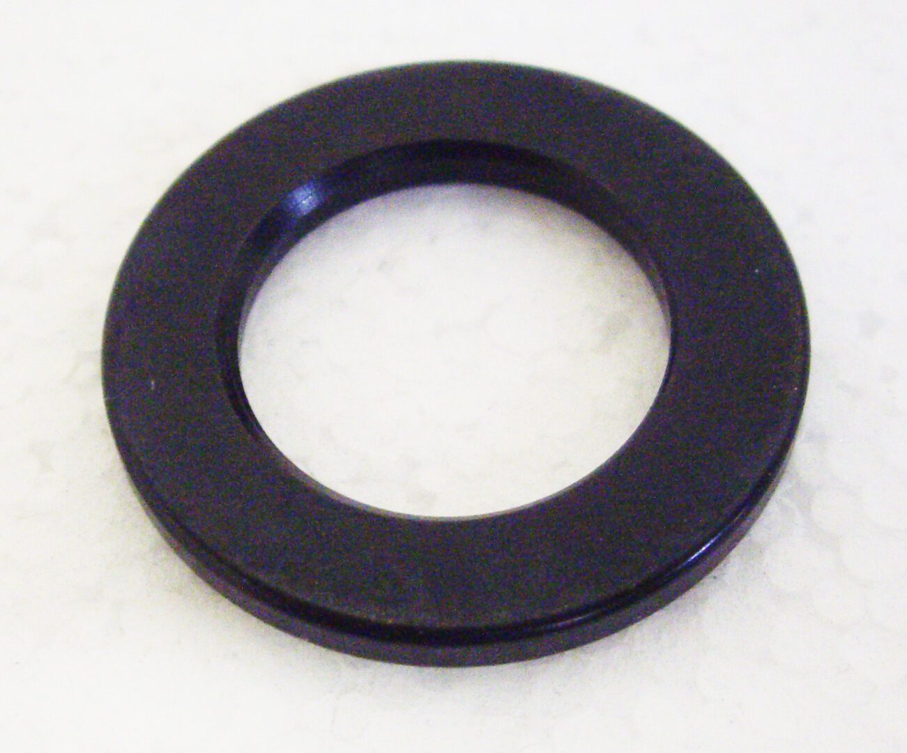 A black washer is sitting on the floor.