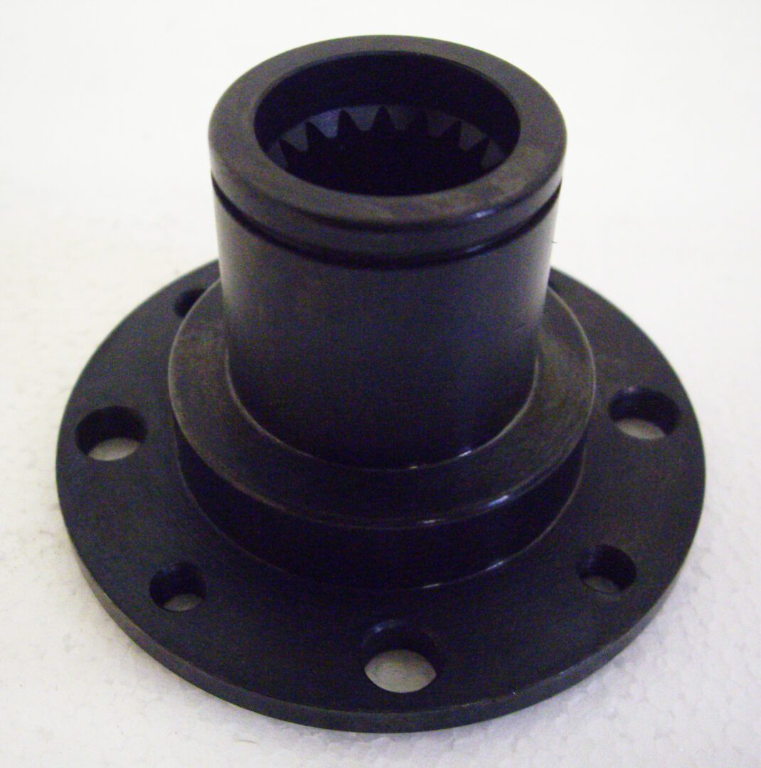 A black plastic part sitting on top of a table.