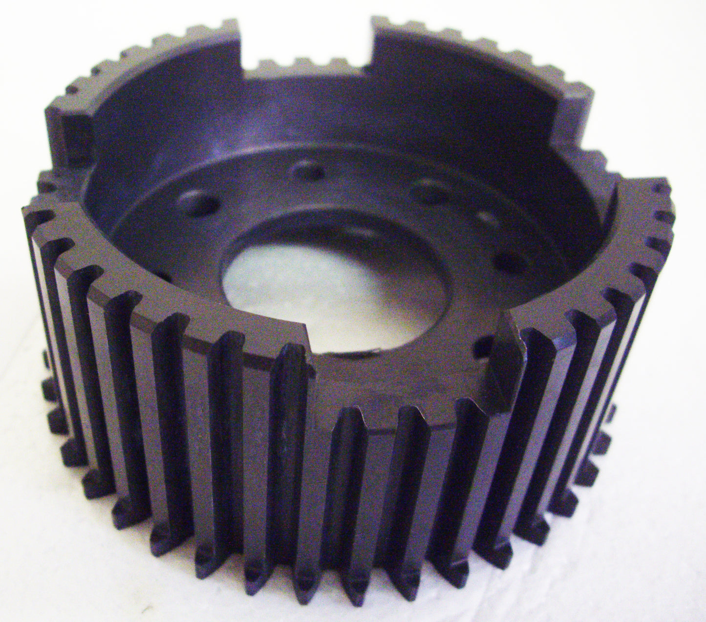 A black plastic gear with a hole in it.