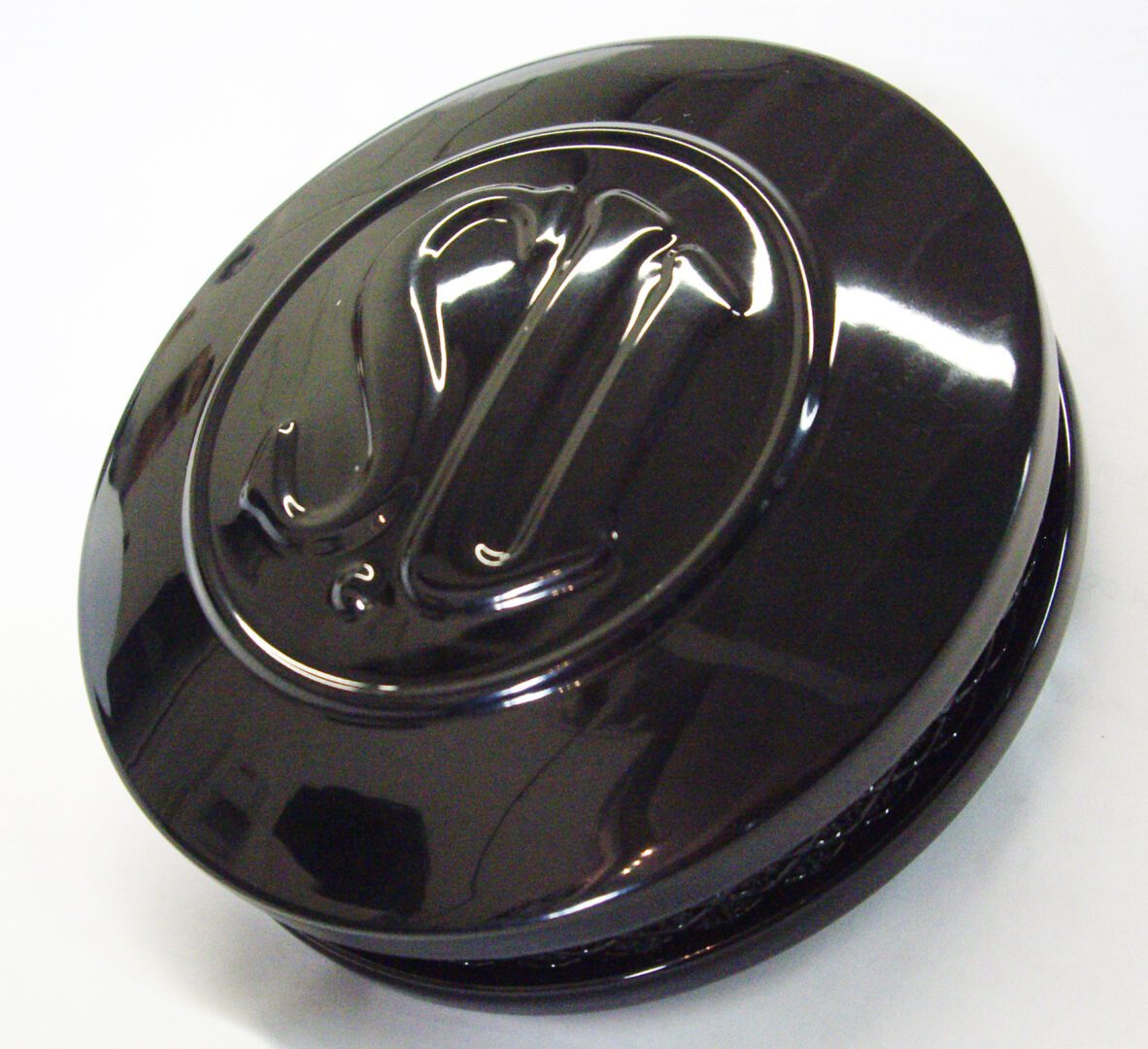 A black plastic cap with the letter u on it.