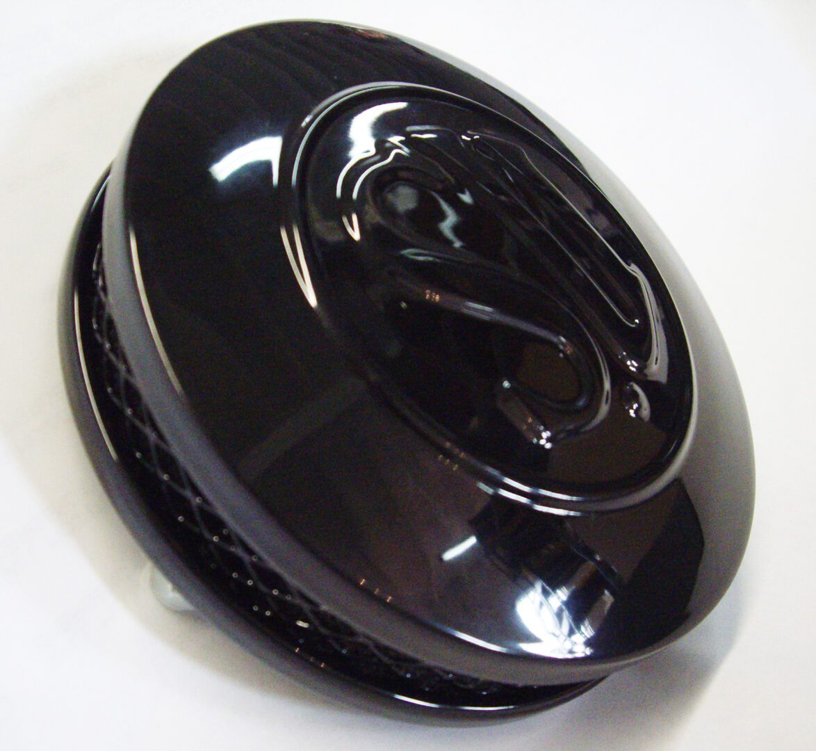 A black plastic container sitting on top of a table.