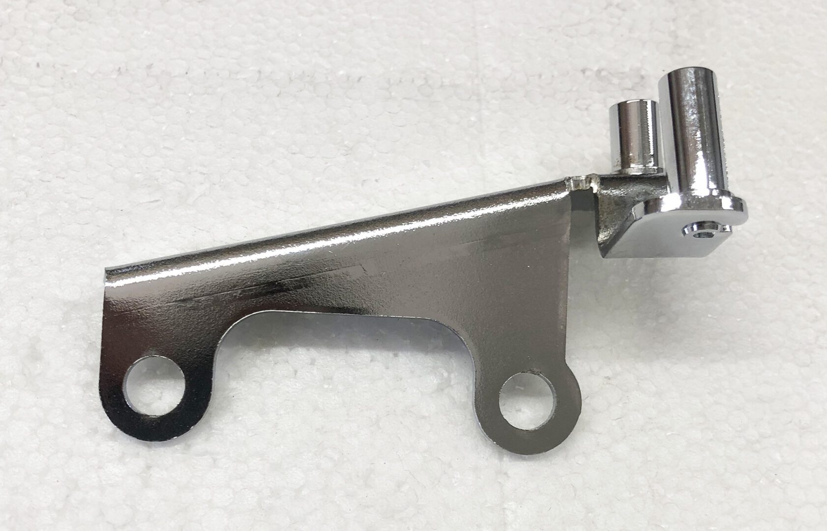 A metal part that is sitting on the ground.