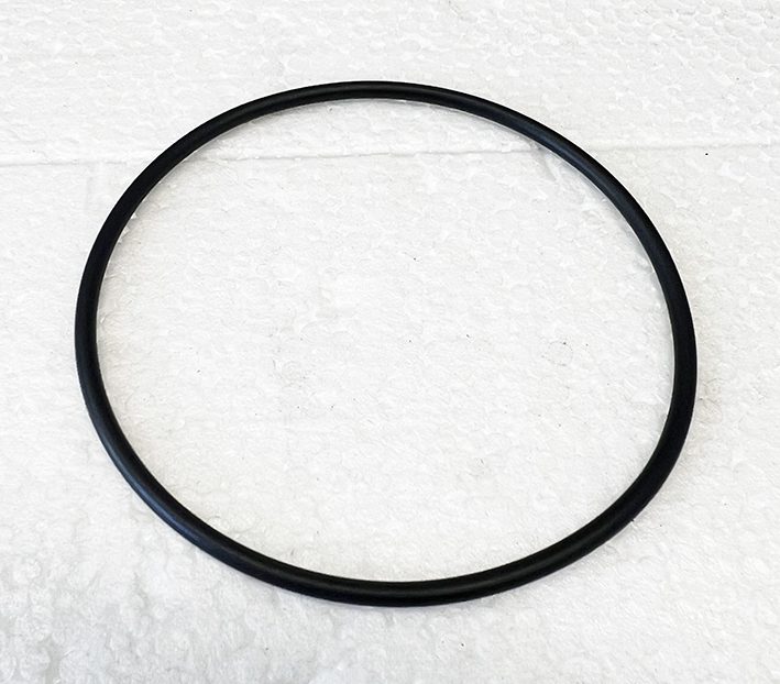 A black rubber ring on top of white paper.