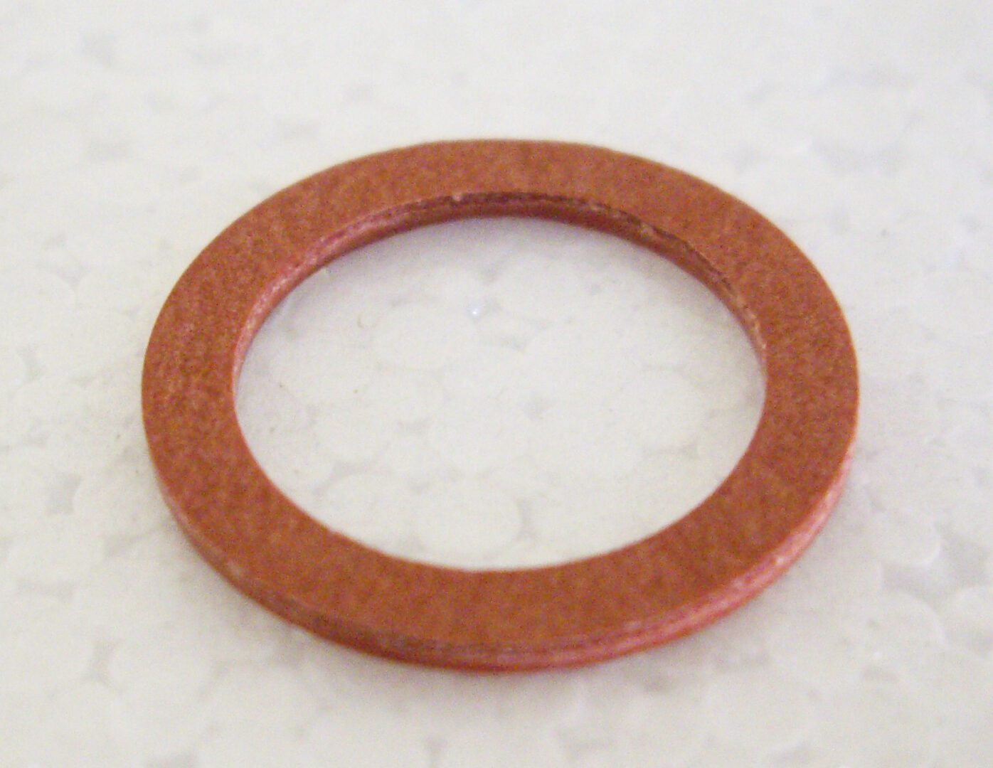 A red washer sitting on top of a white floor.