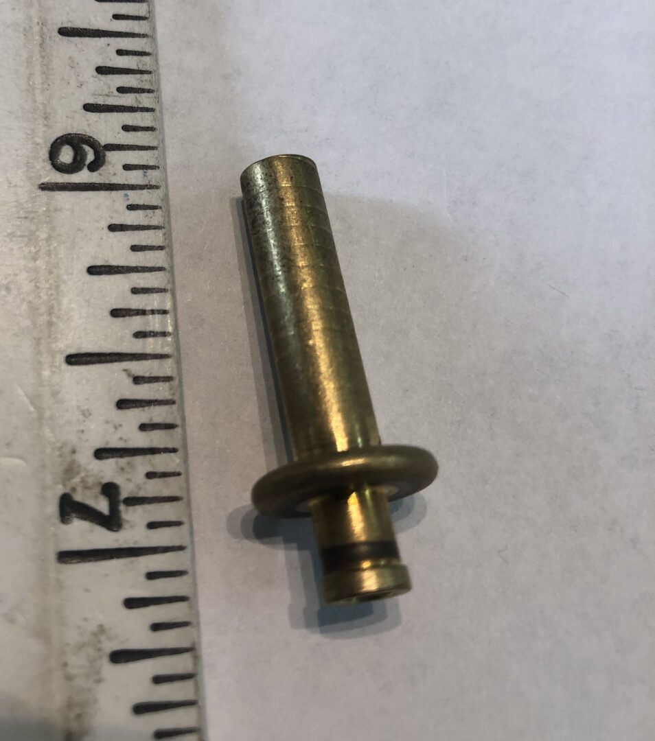 A metal pin with a ruler and a meter