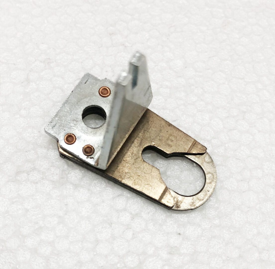 A metal piece of furniture that is missing the handle.