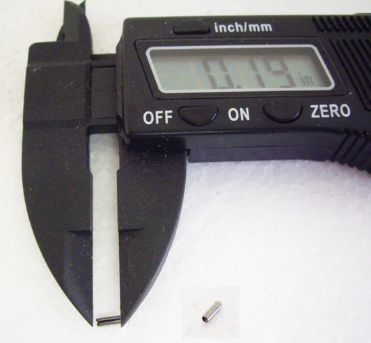 A digital caliper with a small piece of metal in front.
