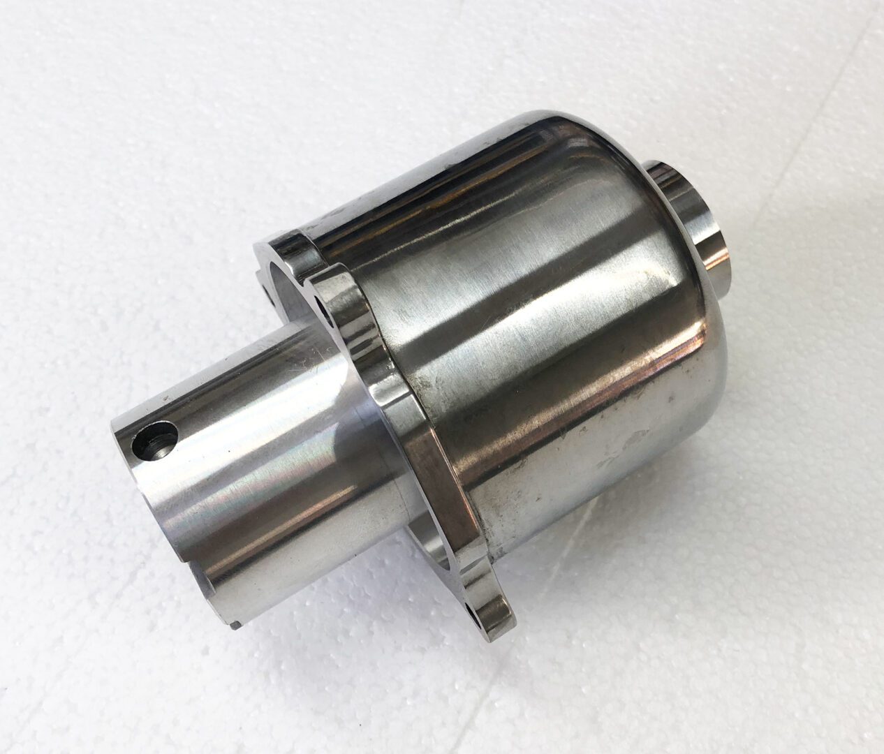 A metal part that is sitting on the ground.