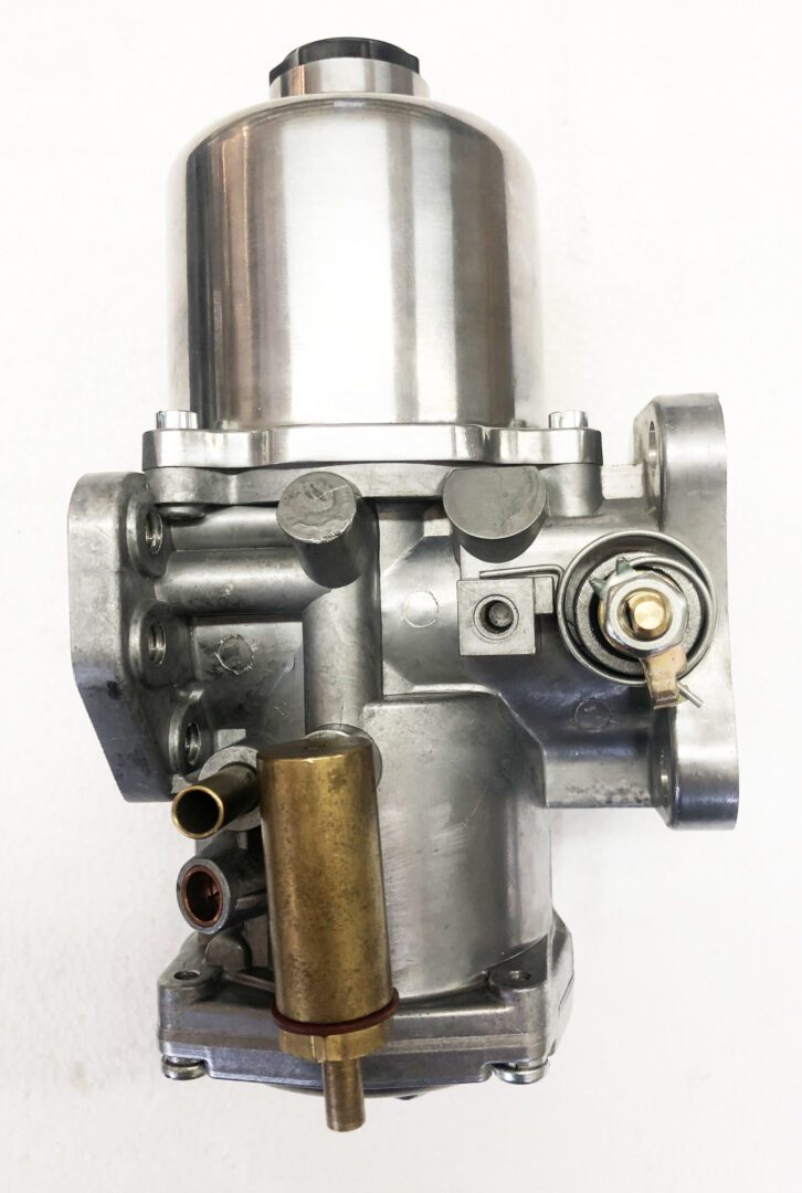 A close up of the carburetor on a motorcycle