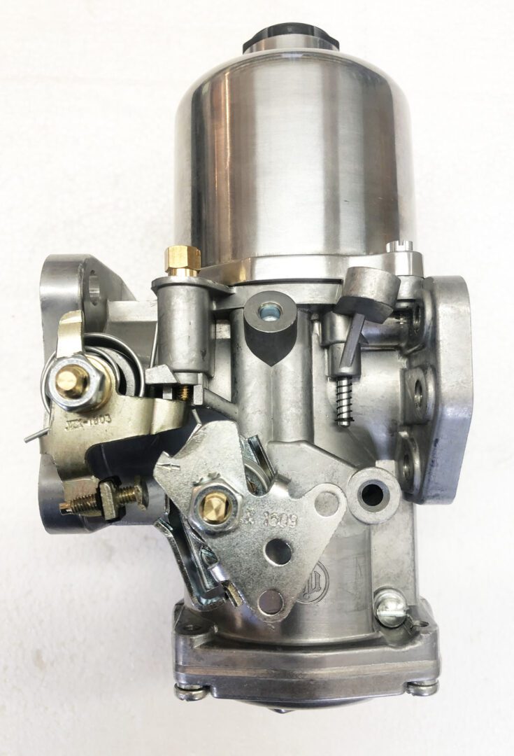 A close up of the carburetor on a motorcycle