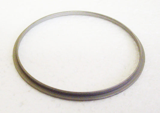 A metal ring sitting on top of a white surface.