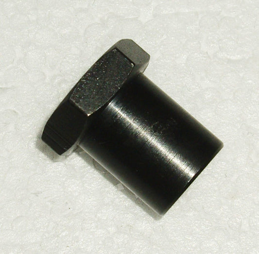 A black nut and bolt sitting on top of a white surface.