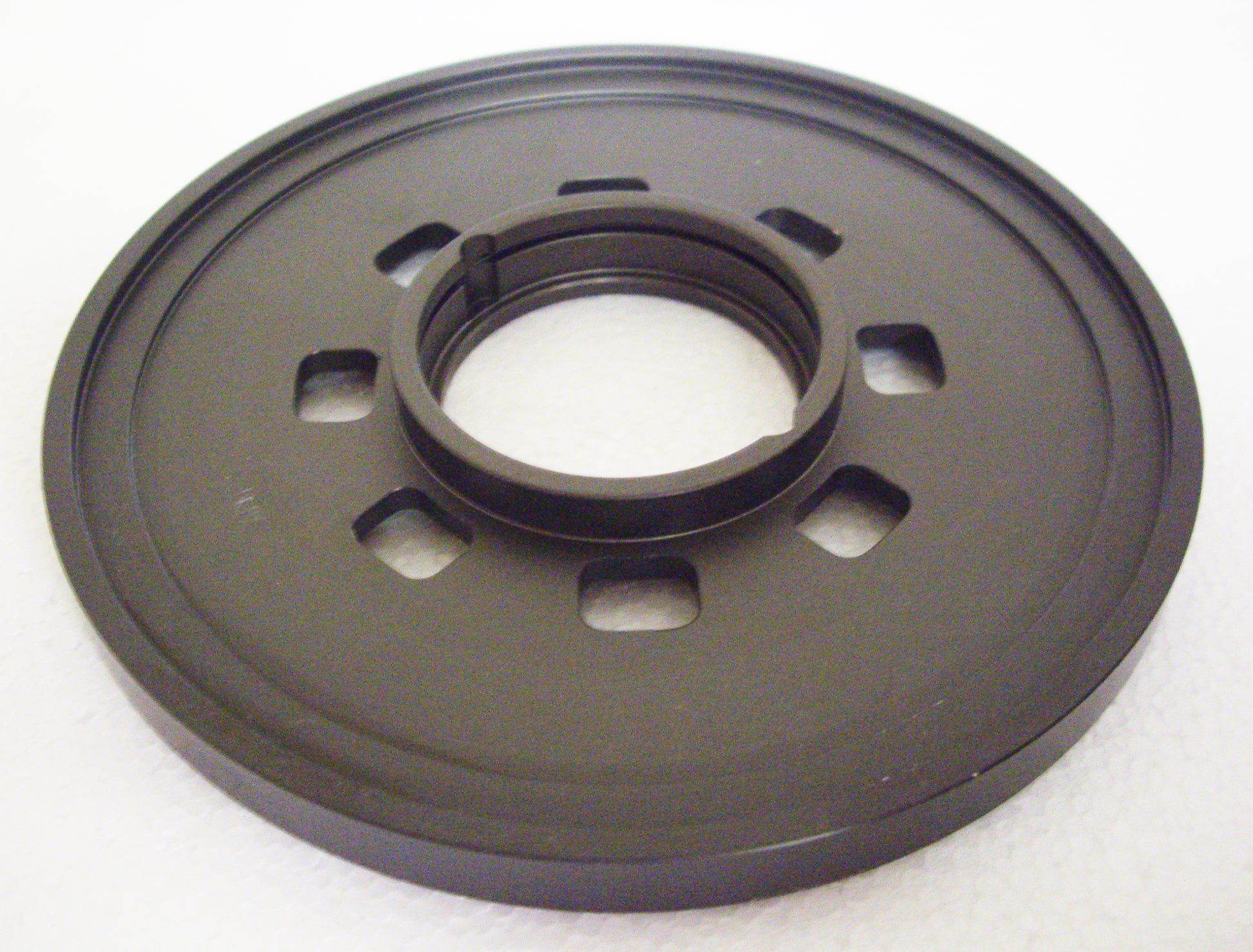 A black plastic disc with a hole in the center.