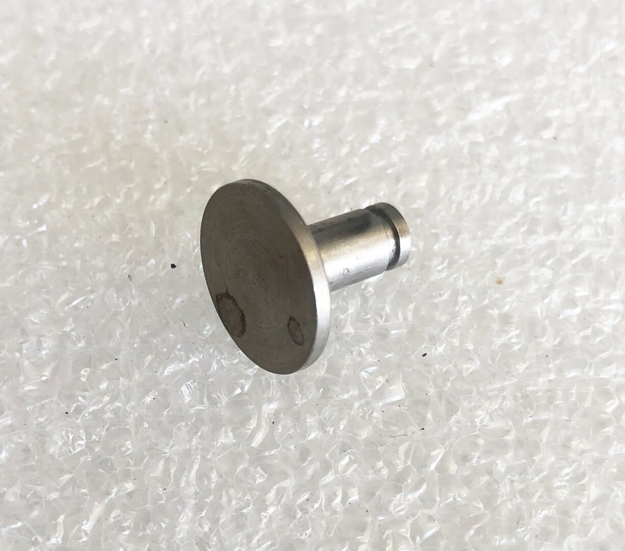 A metal piece of furniture sitting on top of a white floor.