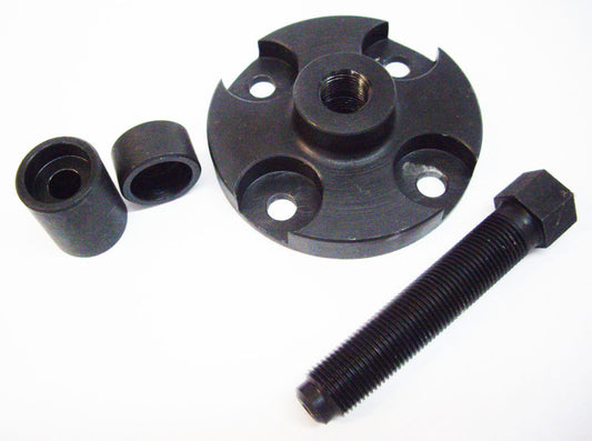 A black plastic object with two small nuts and one large nut.