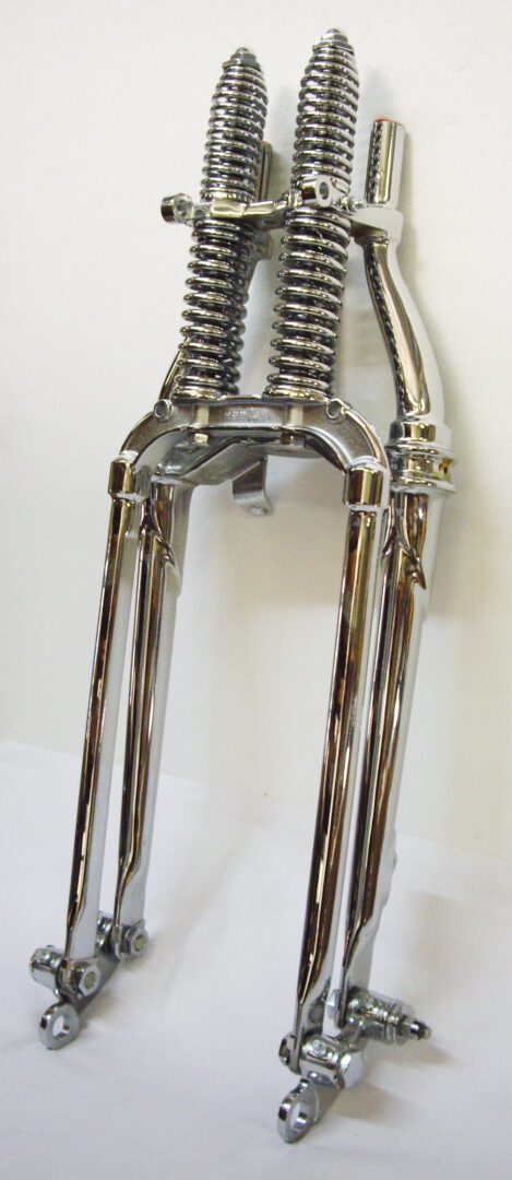 A pair of chrome forks hanging on the wall.