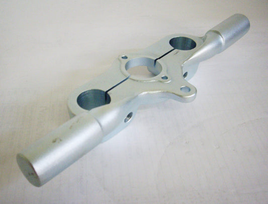 A silver metal pipe sitting on top of a table.