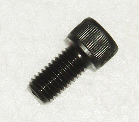 A black screw with a small hole in it.