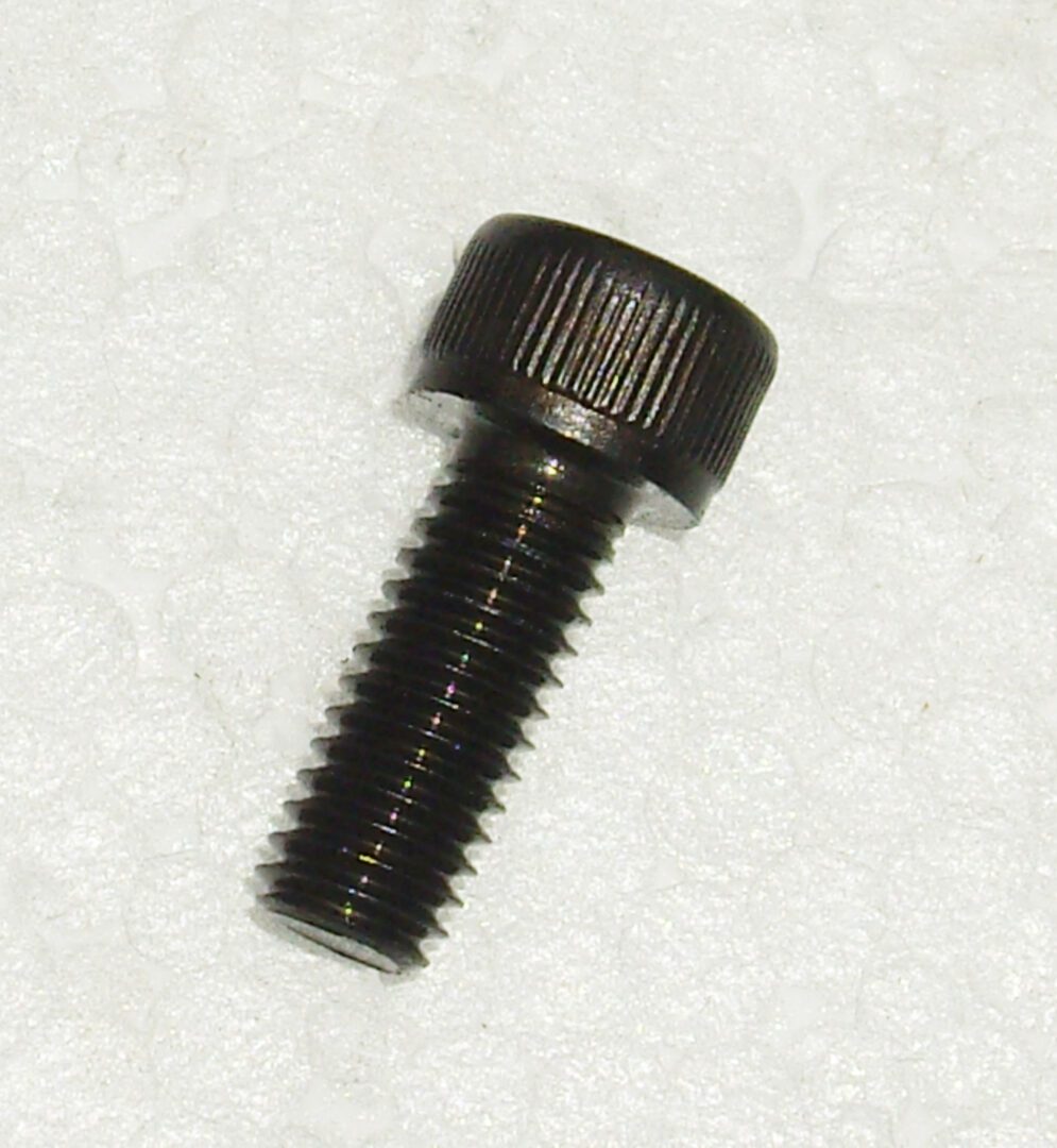 A black screw with a small head on it