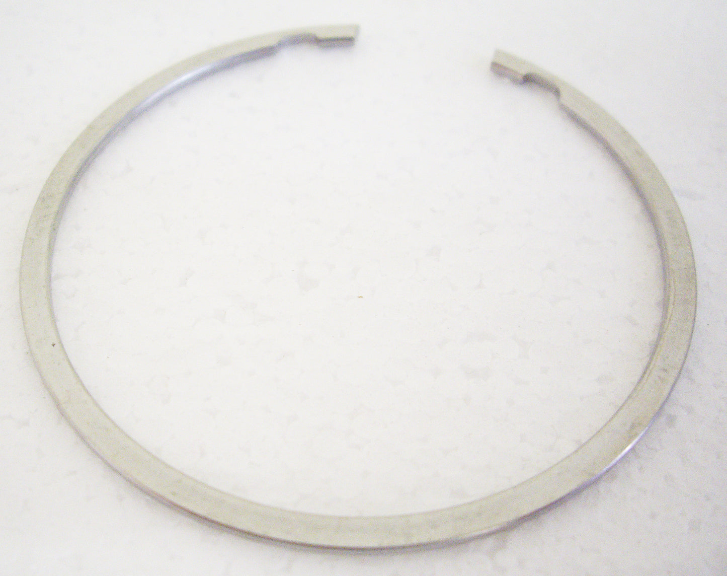 A white background with a metal ring.