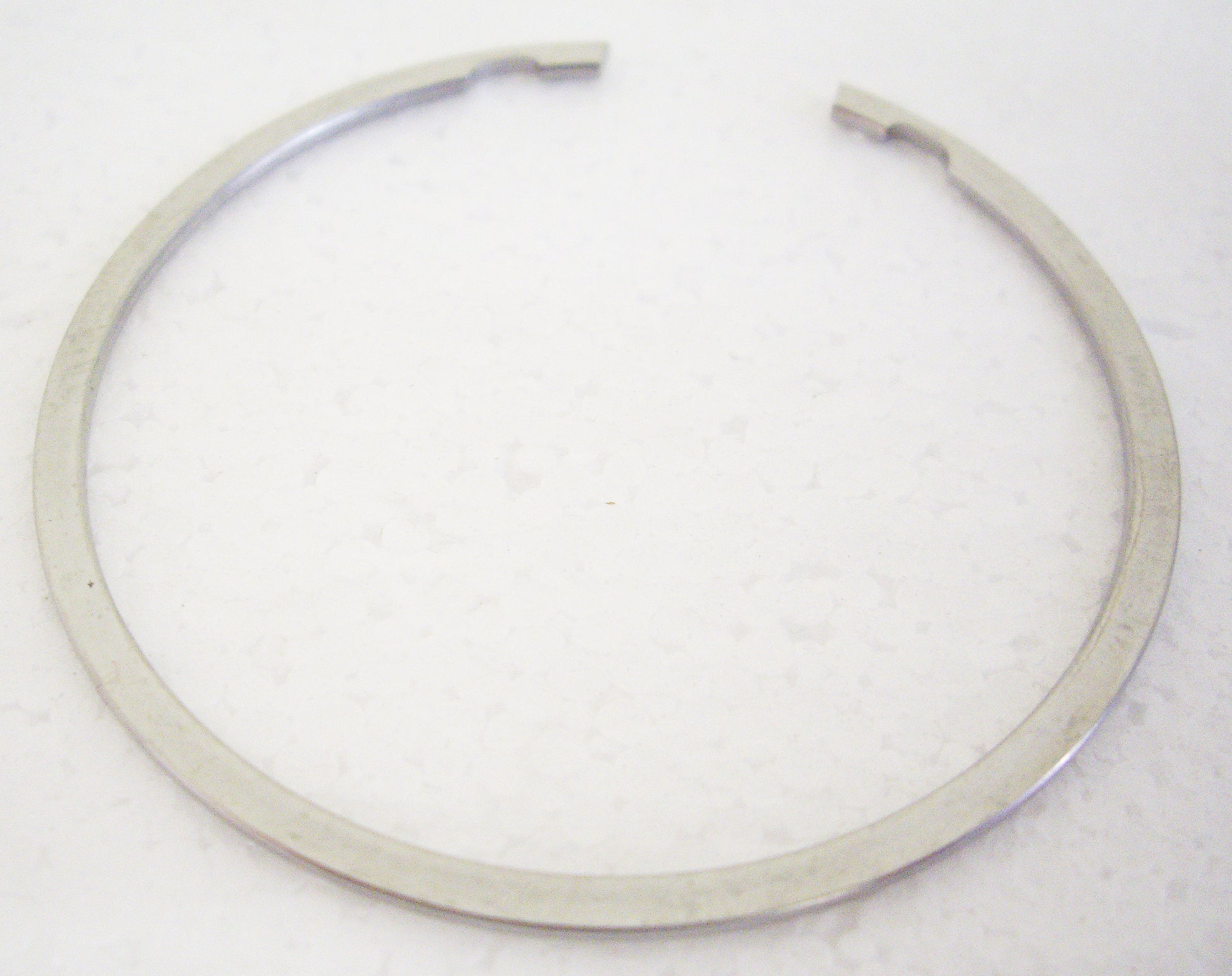 A white background with a metal ring.