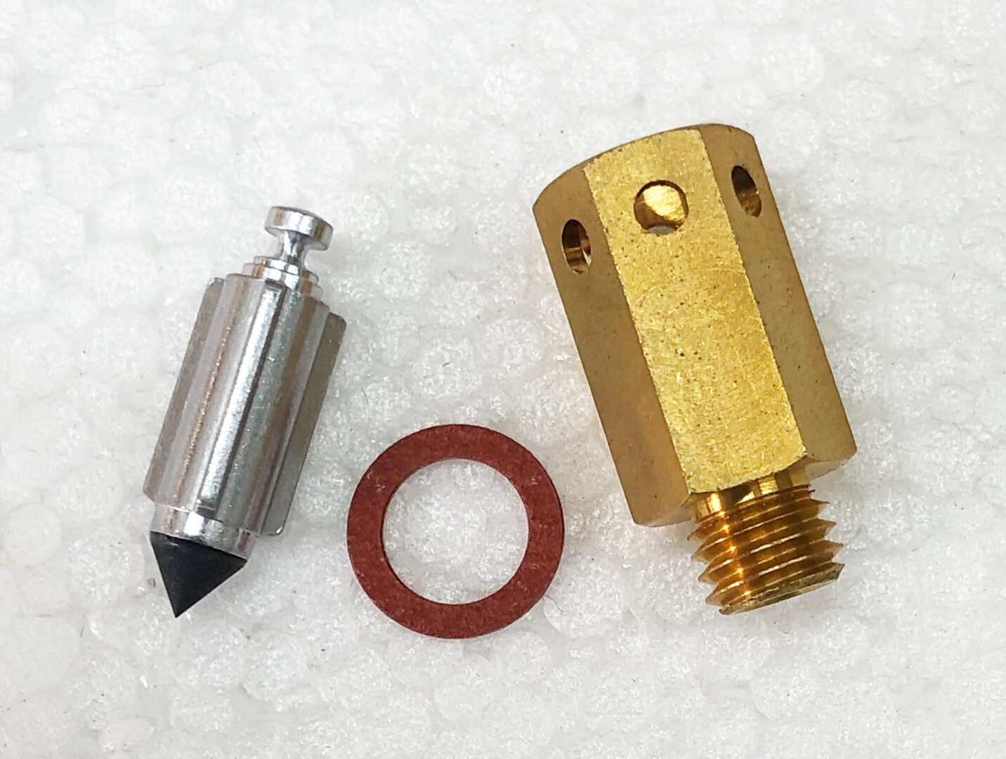 A piece of metal with a small object and some parts