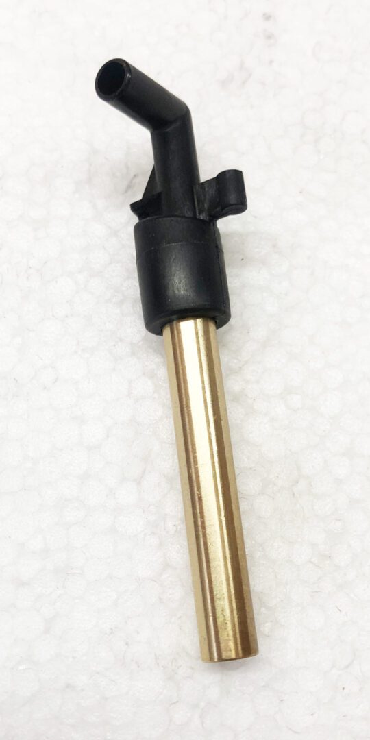 A black and gold pen sitting on top of white ground.