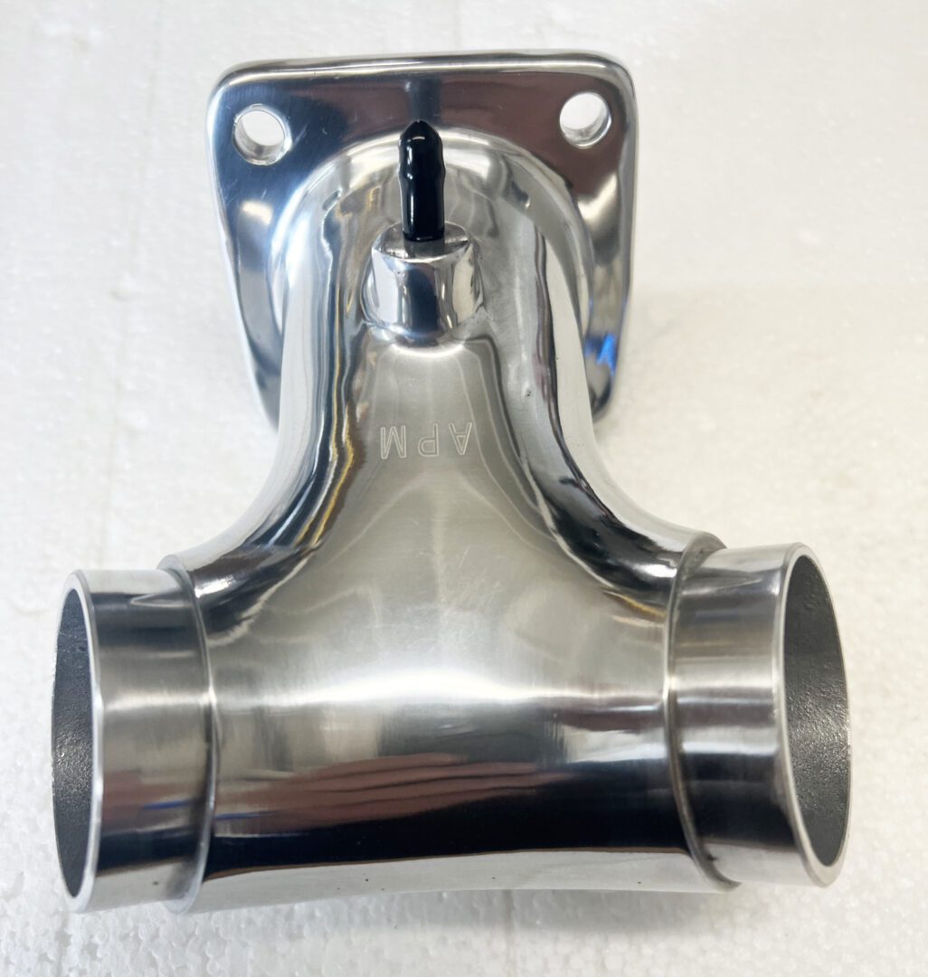 A chrome pipe with two holes on the end of it.