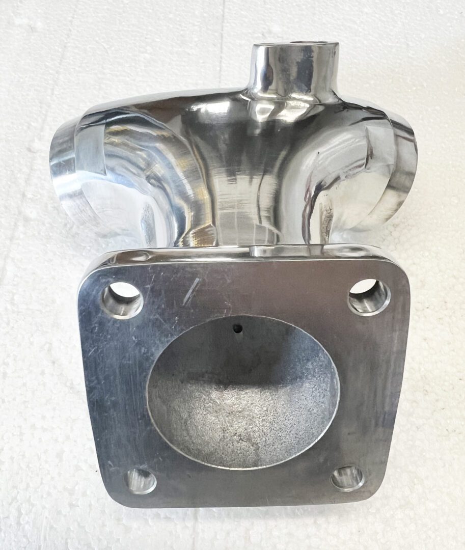 A metal object sitting on top of a white surface.