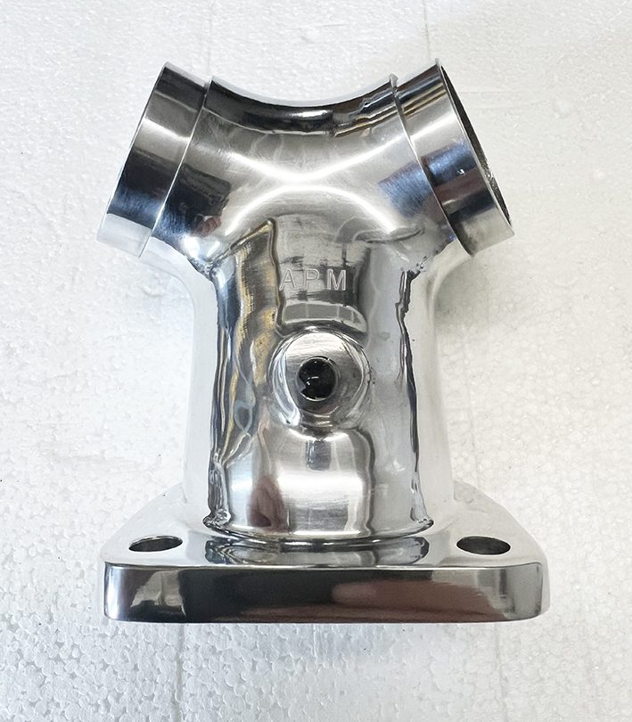 A chrome plated metal part mounted to the wall.