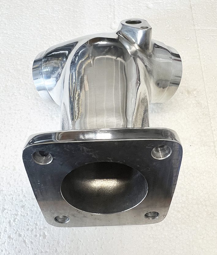 A metal pipe sitting on top of the floor.