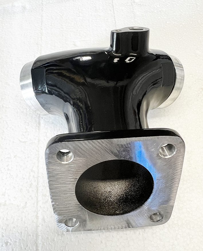 A black and silver metal object on the wall.