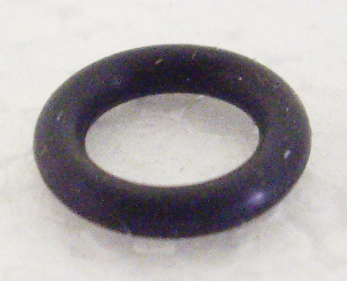 A black rubber ring sitting on top of a white surface.