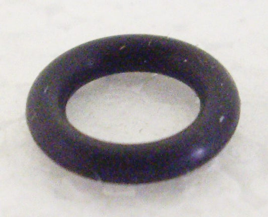 A black rubber ring sitting on top of a white surface.