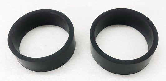 A pair of black rubber rings sitting on top of a white surface.