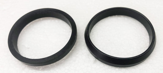 A pair of black rings sitting on top of a white surface.
